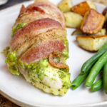 chicken breasts wrapped in bacon on a plate