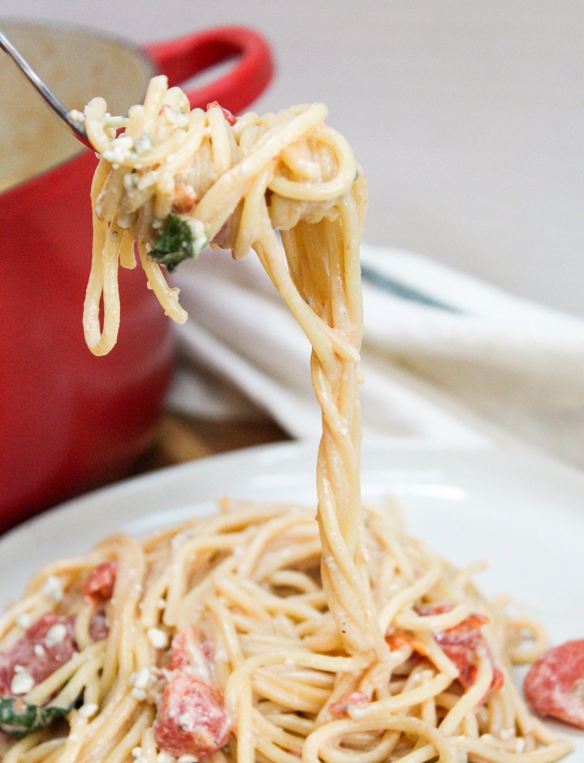 blue cheese and tomato pasta with fork