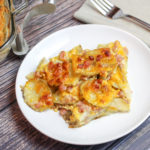 Sliced potatoes, cheese, and diced ham baked in a casserole dish