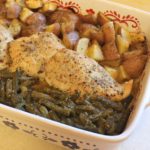 chicken in a baking dish with potatoes and green beans