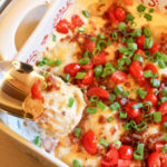 A pierogi scooped from a casserole dish