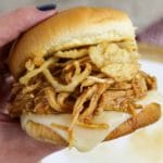 bbq cranberry chicken on a bun held in hand