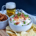 beer dip in a bowl with chips and pretzels