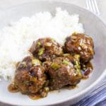 cooked meatballs in dish with rice
