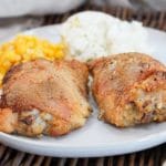 oven fried chicken on a plate with sides