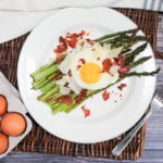 overhead shot of egg and asparagus salad on a plate