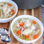 chicken dumpling soup in white bowls
