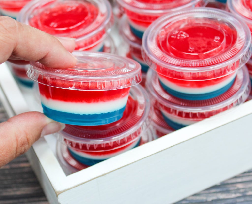 red white and blue jello shots in plastic containers