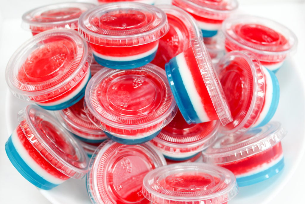 red white and blue jello shots in plastic containers