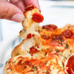 grabbing bites of pizza bread