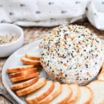 cheese ball on a plate with bagel chips around it