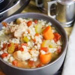 soup in a bowl next to the slow cooker
