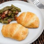 plated chicken crescent with green beans on the side