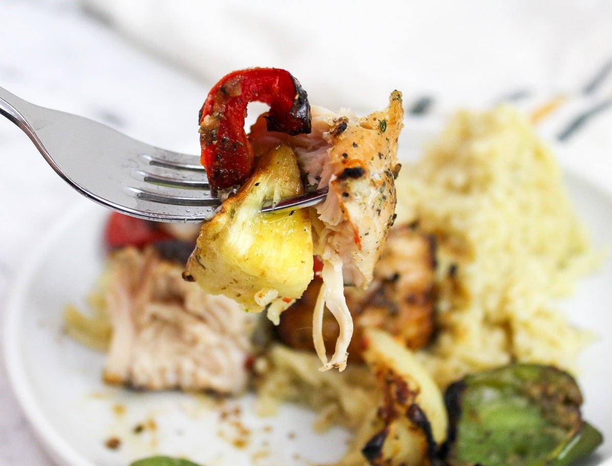 chicken and pineapple on a fork