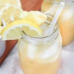 pineapple bourbon lemonade in glass with pineapple and lemon garnish