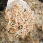 slow cooker sausage stuffing on a spoon