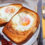 air fryer egg toast on a plate with bacon