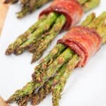 air fryer bacon wrapped asparagus on a plate.