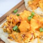 naan breakfast pizza on a cutting board