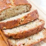Sliced Rhubarb Banana bread on a wooden cutting board.