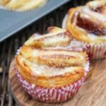 individual cinnamon rolls in a muffin tin with a glaze on top.