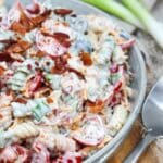 pasta salad in a gray bowl with a spoon on the side.