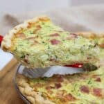 zucchini quiche sliced and lifted from the pan.