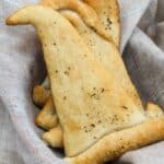 crescent rolls shaped like witch hats topped with chopped parsley.