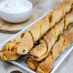Twisted dough breadsticks with pumpkin puree. Topped with cinnamon and sugar with a side of whipped cream.